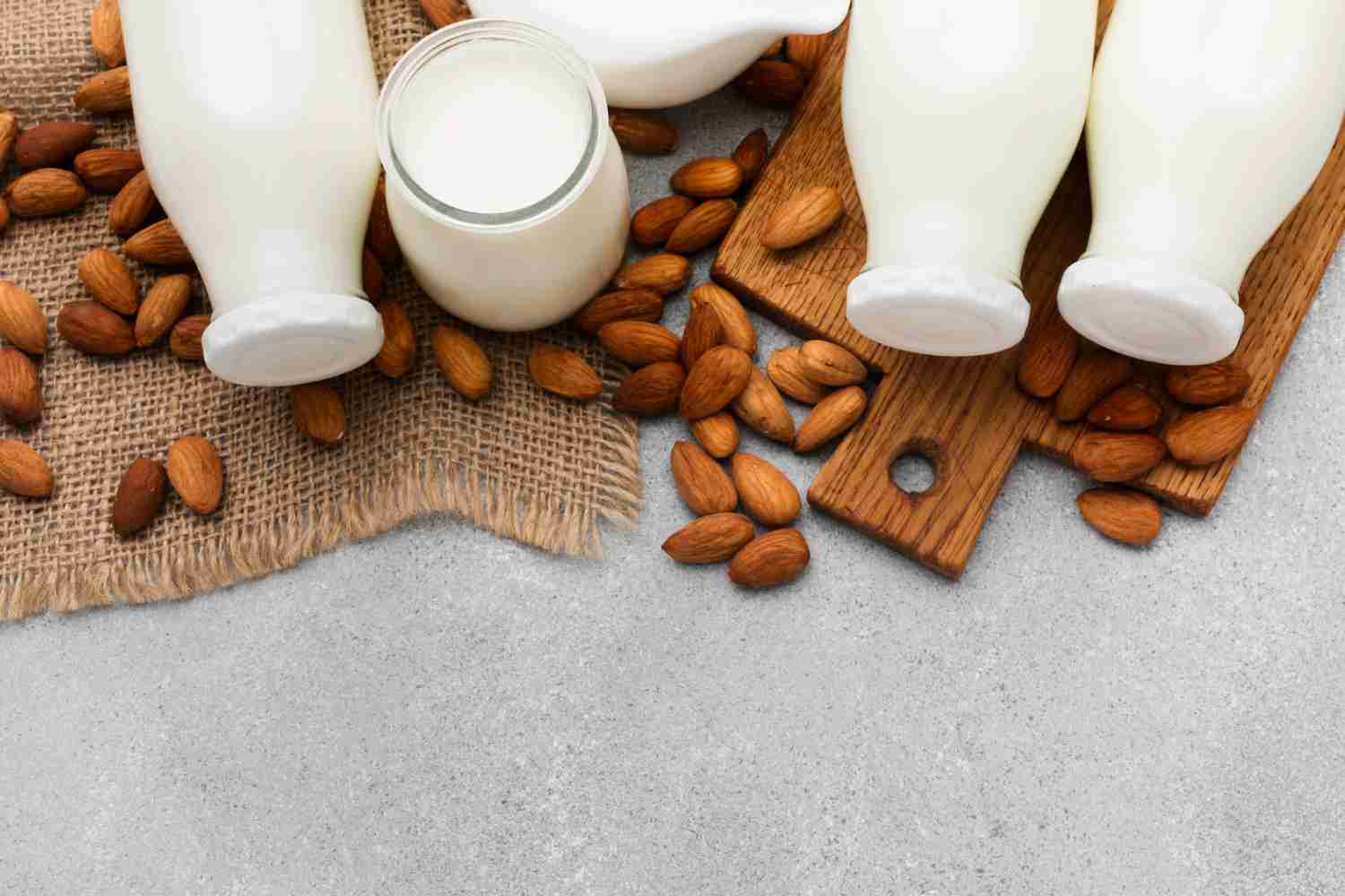 Alternative milks for coffee on a table with some coffee beans and decorations